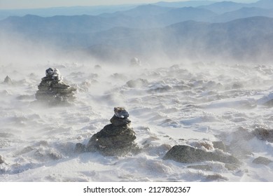 Rock Cairns Marking Trail Obscured By Blowing Snow On Mount Washington In New Hampshire. Severe Inclement Weather On Hiking Trail