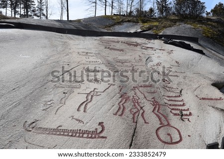 Rock carvings from the Bronze Age, which show a fight and boats and were painted with red paint, Tamumshede, Sweden