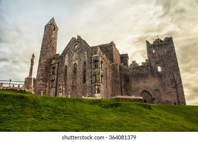 Rock Of Cashel Ruins Of Cormac's Chapel In Ireland With Cloudy Sky At The Background