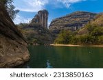 A rock cliff lining the nine bend river or Jiuxi in Wuyishan or Mount wuyi scenic area in Wuyi China in fujian province, blue sky with copy space for text