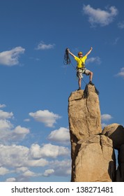 Rock climber balances on the summit after a successful and challenging ascent. - Shutterstock ID 138271481