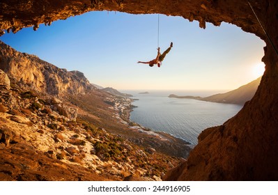 Rock Climber Hanging On Rope While Lead Climbing 