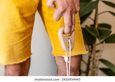 rock climber male hand holding finger strength training board with two fingers. climbing workout at home. rock climber's hand close-up. fingerboard and hangboard
 - Powered by Shutterstock