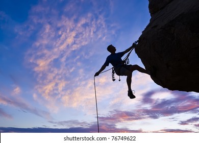 Rock climber rappells from the summit after a successful ascent. - Powered by Shutterstock