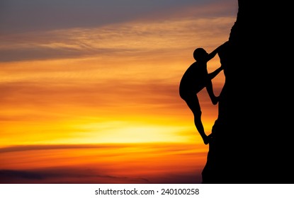 Rock climber at sunset background. Sport and active life 