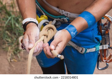 Rock climber tying and tightening figure 8 knot - Powered by Shutterstock