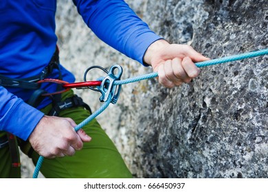 Rock Climber Wearing Safety Harness And Climbing Equipment Outdoor, Close-up Image