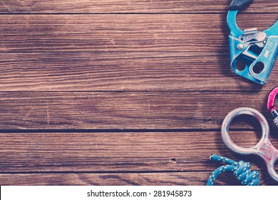 Rock Climbing Equipment On Wooden Background