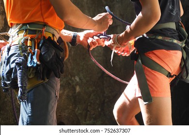 Rock climbing instructor is coaching how to tie knot - Powered by Shutterstock