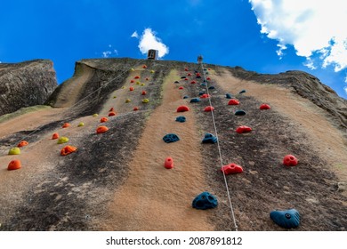 Rock climbing plastic holds in a multi coloured rockface 