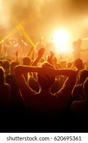 Rock Concert, Cheering Crowd In Front Of Bright Colorful Stage Lights, Hands Behind The Head With Pleasure From The Show