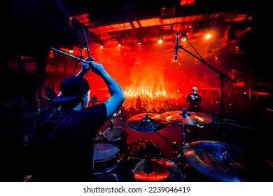 Rock concert poster. A drummer plays drums during a show. Band on stage
				