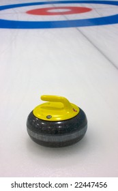 Rock draws to the button on the curling ice