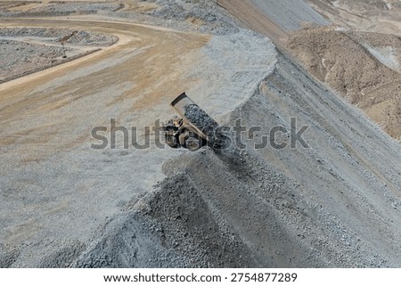 Rock dumping process at a mining waste dump using a huge mining truck