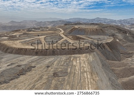Rock dumping process at a mining waste dump using a huge mining truck