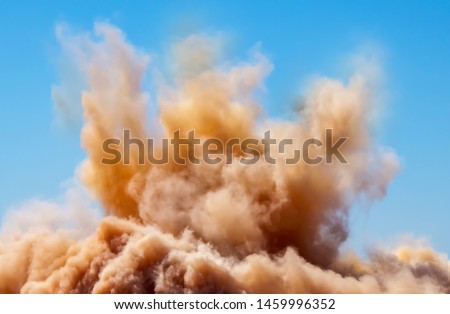 Rock dust clouds during detonator blasting on the mining site 