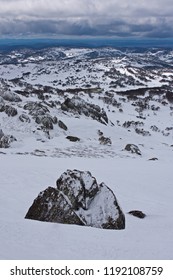 A Rock In The Forefront And Snow Covered Hill In The Background In Perisher Snow Resort In New South Wales In Australia In Winter