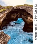 Rock formation with rushing water blue atmosphere cool colors cliffs on shoreside in Puerto Rico