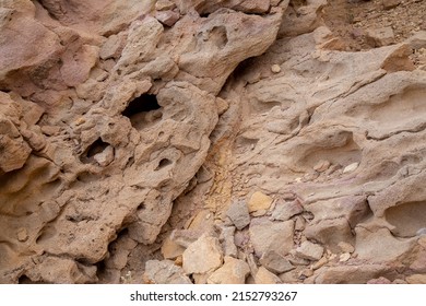 Rock Formation With Sand And Lava Rock In Desert With Grain And Out Of Focus Up Close