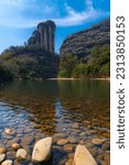 Rock formations lining the nine bend river or Jiuxi in Wuyishan or Mount wuyi scenic area in Wuyi China in fujian province, vertical image with copy space for text
