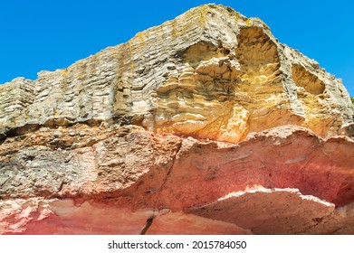 rock formations in yellow and pink on the sky background. rare karst shapes.White chalk and red sandstone geological layer.rock structure close-up. view of the geologic history - Shutterstock ID 2015784050