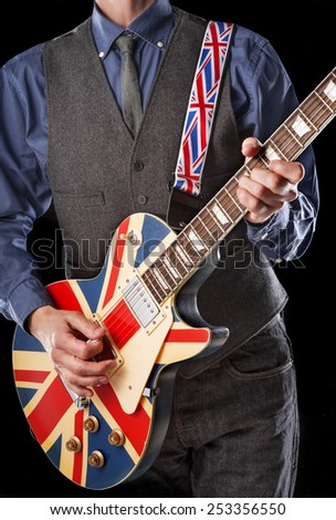 rock guitarist playing a vintage electric guitar with united kingdom flag painted