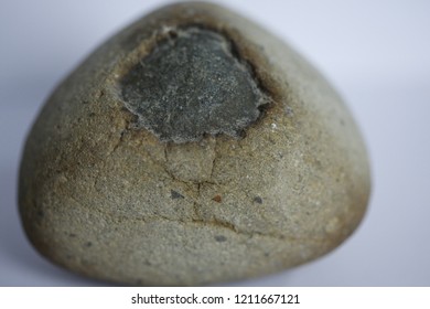 A rock with a hole in the outer layer.