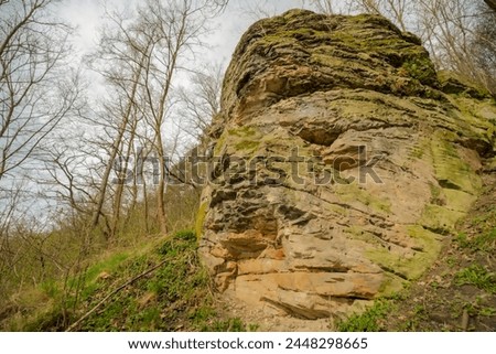 Rock - inselberg - a large stone in the hillside. Geological attraction - a huge post-glacial boulder on the slope of a gorge in the Swietokrzyskie Voivodeship. 
