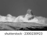 A Rock Ledge for a Product Display, Showing Close Detail the Centre Top Surface of the Stone with a Fictitious Cloud and Mountain Blurred Background.