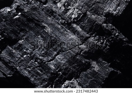 Rock lump of coal macro shot, detail texture dark background with coal