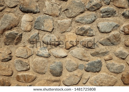Rock mortar wall with round stone texture  