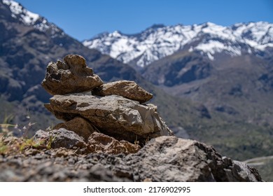 Rock Mound Made By Hikers With The Snow Capped Andes Mountains Behind