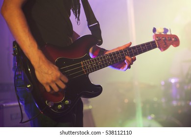 Rock Music Background, Bass Guitar Player, Closeup Photo With Soft Selective Focus