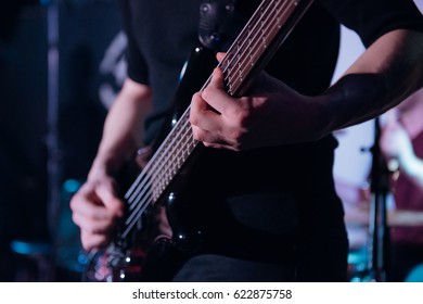 Rock Music Background, Bass Guitar Player, Closeup Photo With Soft Selective Focus