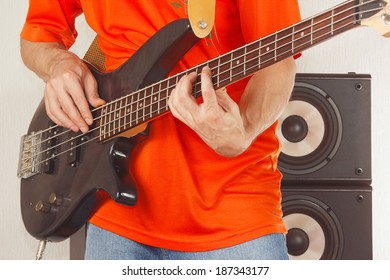 Rock Musician Playing The Electric Bass Guitar Closeup