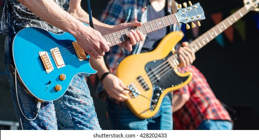 Rock Musicians Playing At Live Stage.