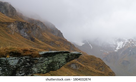 Rock Outcrop And Cold, Glacial Landscape In The Background