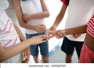 Rock papers scissors. Children playing rock papers scissors while having controversy about school issues
