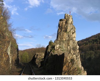 Rock pillar named "Pikovická jehla" ("Pikovice Needle") in the valley of Sázava river, Czech republic. A train track of a local railway passes nearby.  - Shutterstock ID 1313590553