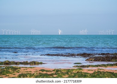 Rock Pool At Botany Bay In The Seaside Town Of Broadstairs, East Kent, England, With Floating Offshore Wind Farms At Horizon