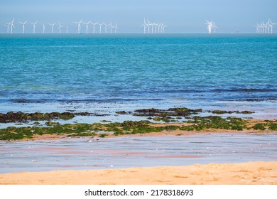 Rock Pool At Botany Bay In The Seaside Town Of Broadstairs, East Kent, England, With Floating Offshore Wind Farms At Horizon