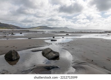 Rock Pools On A Beautiful Deserted Sandy Beach In Lyme Regis Dorset England Jurassic Coast