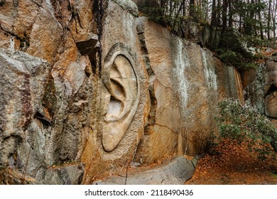 Rock relief called Bretschneiderovo ucho,Bretschneider ear, in forest near Lipnice nad Sazavou,Czech Republic.Tourist destination in Czech countryside.Colorful fall trees,outdoor modern art.