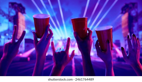 Rock and roll live concert event. People attending live concert, having fun, drinking beer, dancing. Concept of party, celebration, leisure activity, fun, night life - Powered by Shutterstock