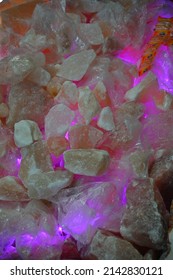 Rock salt (from Himalaya) displayed for sale. It is consumed  Nav Ratri (Hindu Festival) in religious fervor. Rock Salt composition in led light. Rock Salt sold in Lucknow near a godess temple. - Shutterstock ID 2142830121