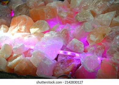 Rock salt (from Himalaya) displayed for sale. It is consumed  Nav Ratri (Hindu Festival) in religious fervor. Rock Salt composition in led light. Rock Salt sold in Lucknow near a godess temple. - Shutterstock ID 2142830127