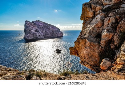A rock in the sea near the mountain coast. Coastal landscape with sea rock. Seaside rock in sea on coastal landscape. Sea rock view