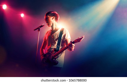 Rock Singer With A Guitar In Stage Lights