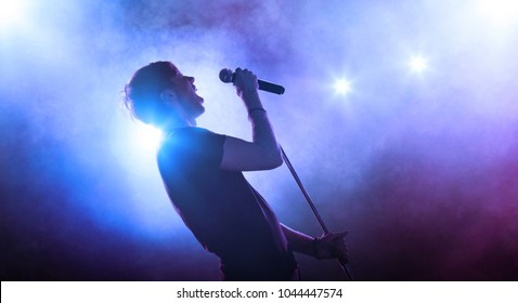 Rock Singer Performing On Stage With Microphone