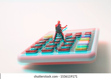 Rock star performing a guitar solo on a calculator. Fun with math, accounting, algebra, taxes and numbers. Crunching numbers can be cool and fun.